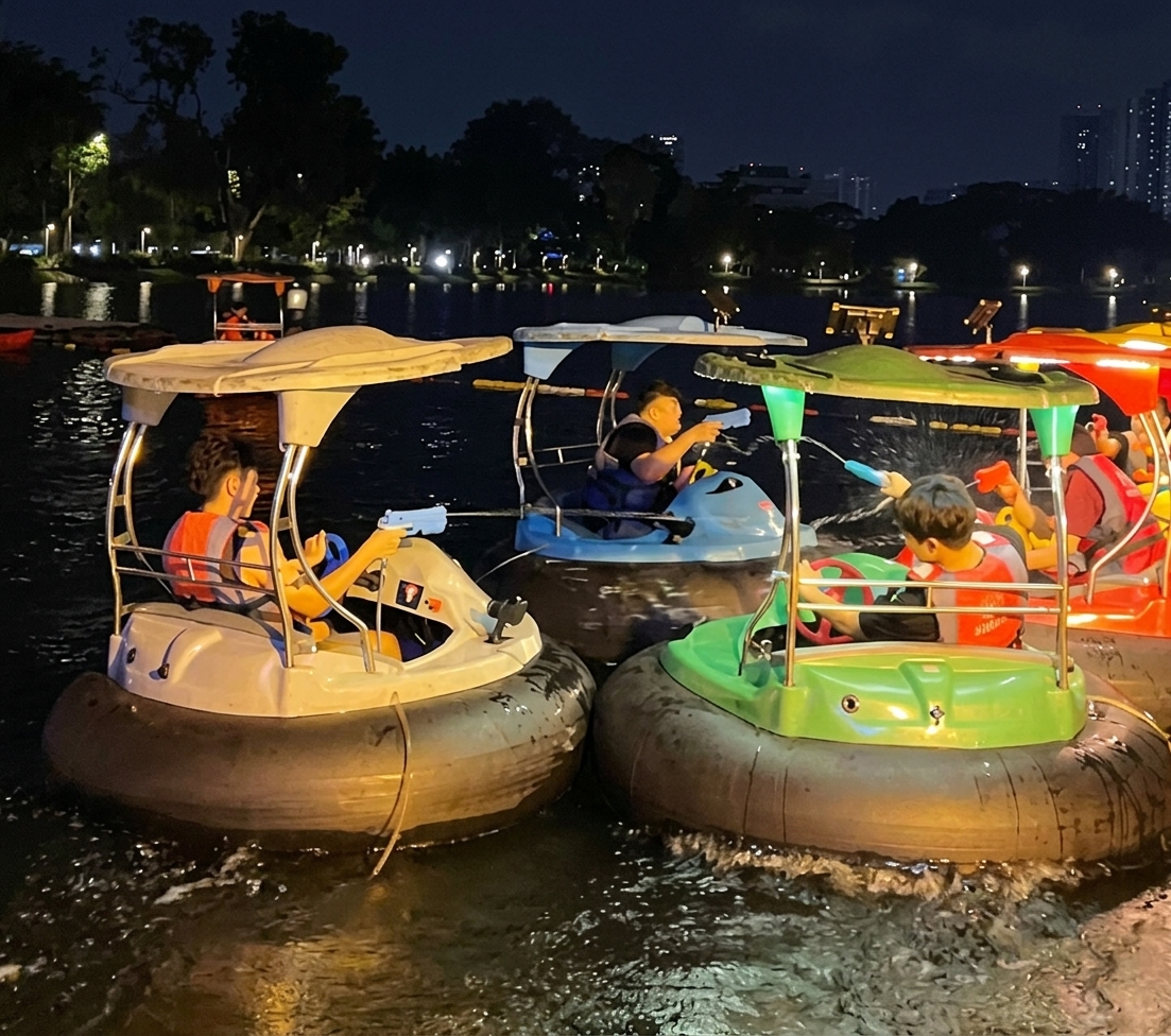 Night bumper boats with glowing water guns on Tasik Titiwangsa